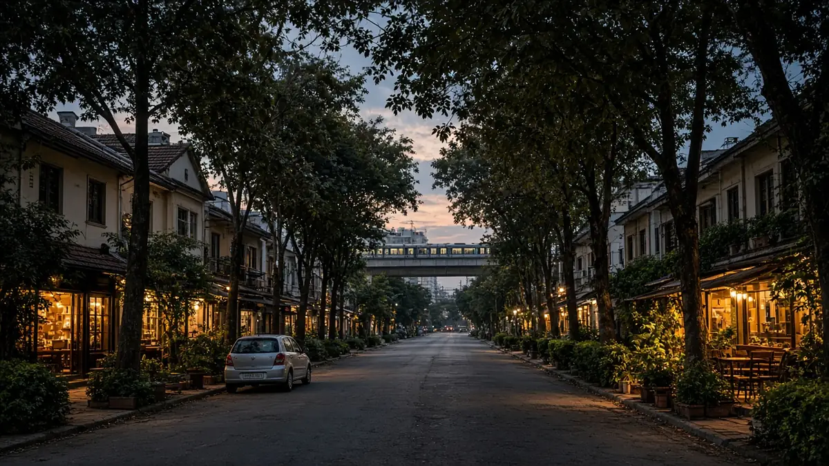 Indiranagar tree-lined street with lit shopfronts at dusk